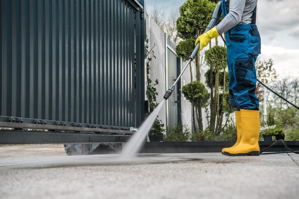 Worker,Wearing,Protective,Uniform,And,Yellow,Rubber,Boots,Cleaning,The